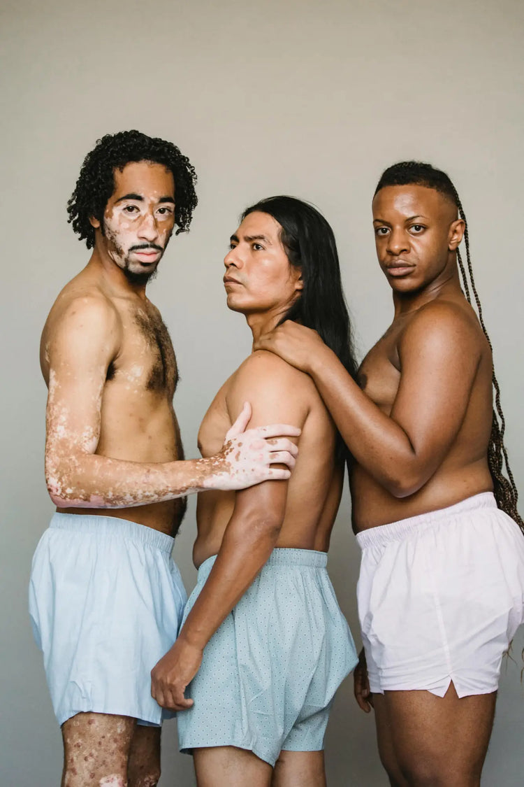 Three people in light shorts posing in a creative portrait for Men’s Underwear & Swimwear.