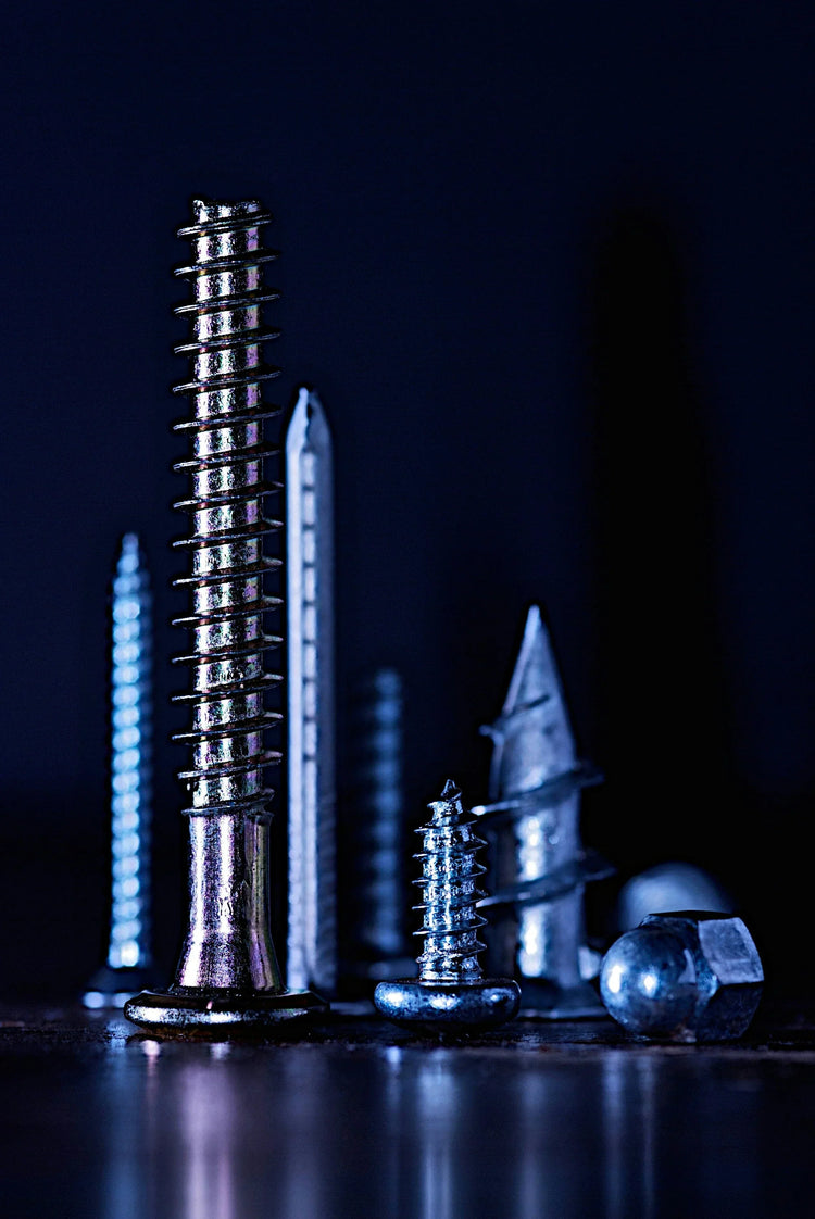 Metal screws and bolts on a reflective surface in Tool Accessories collection