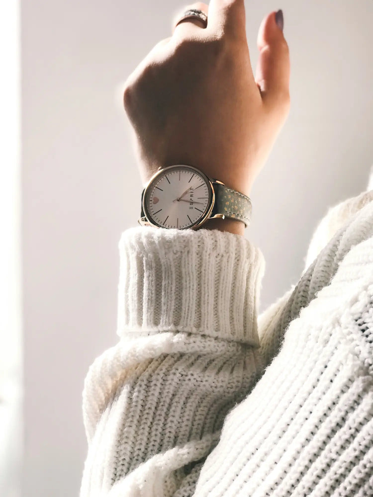 Silver analog wristwatch paired with a cozy white knit sweater in Women’s Watches collection.