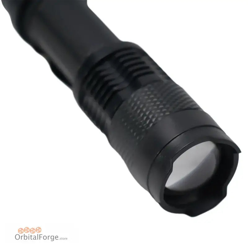 Black tactical flashlight with an adjustable zoom lens head.