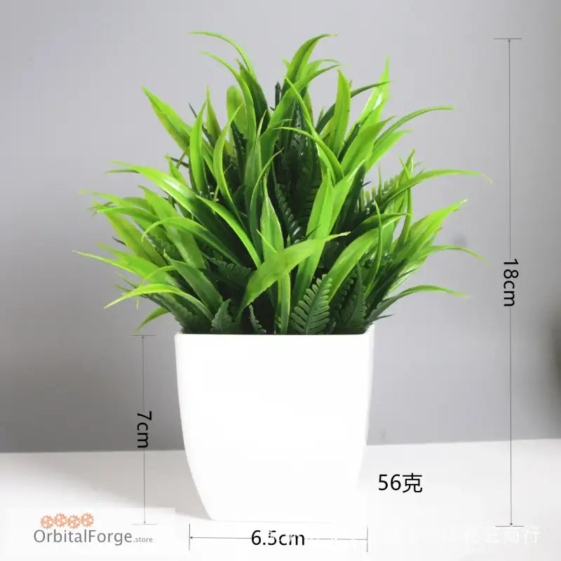 Artificial green plant in a white square pot.