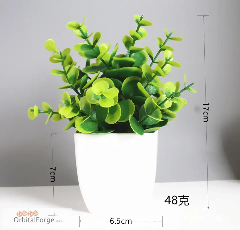 Artificial green plant in a white pot.