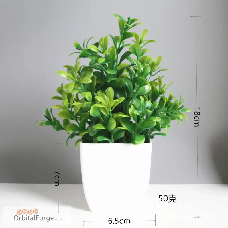 Artificial green plant in a white ceramic pot.