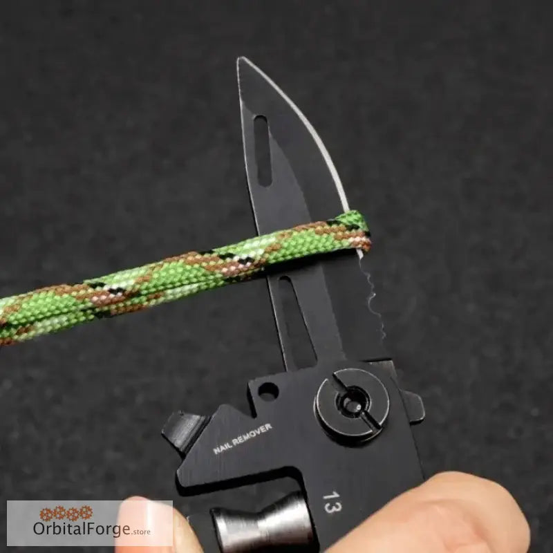 Black metal multi-tool with a rope or cord cutter attachment.