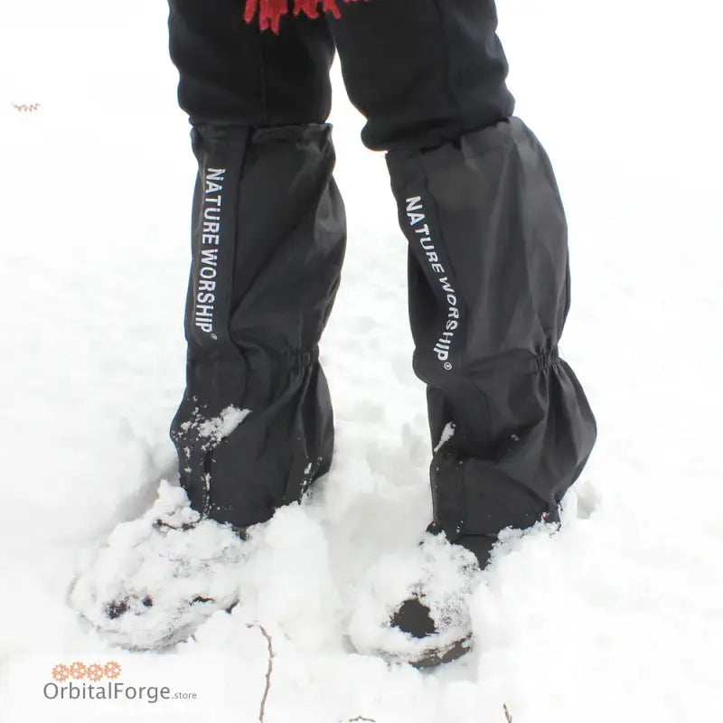 Black waterproof gaiters with Velcro & zip worn over boots in snowy conditions