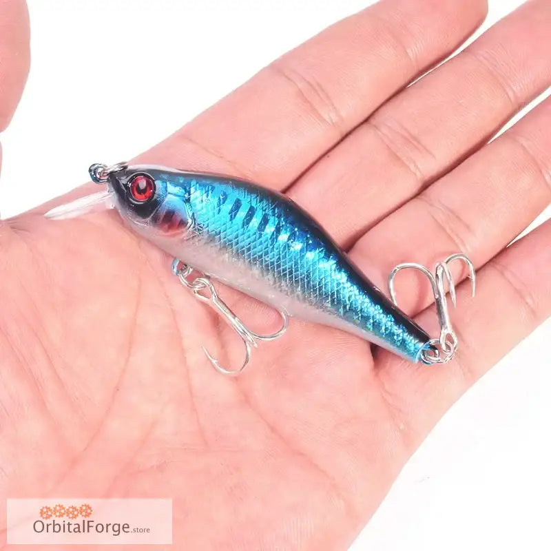 Metallic blue fishing lure with treble hooks, durable hard plastic for predatory fish