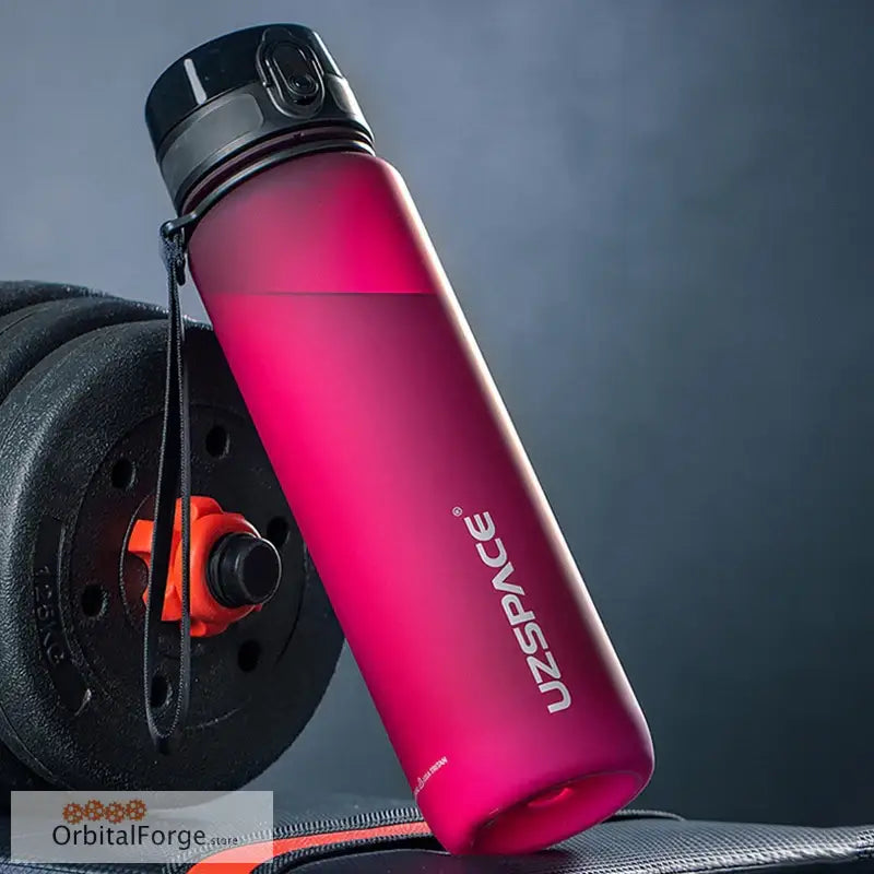 Pink matte water bottle with a black cap and ’UZSPACE’ branding.