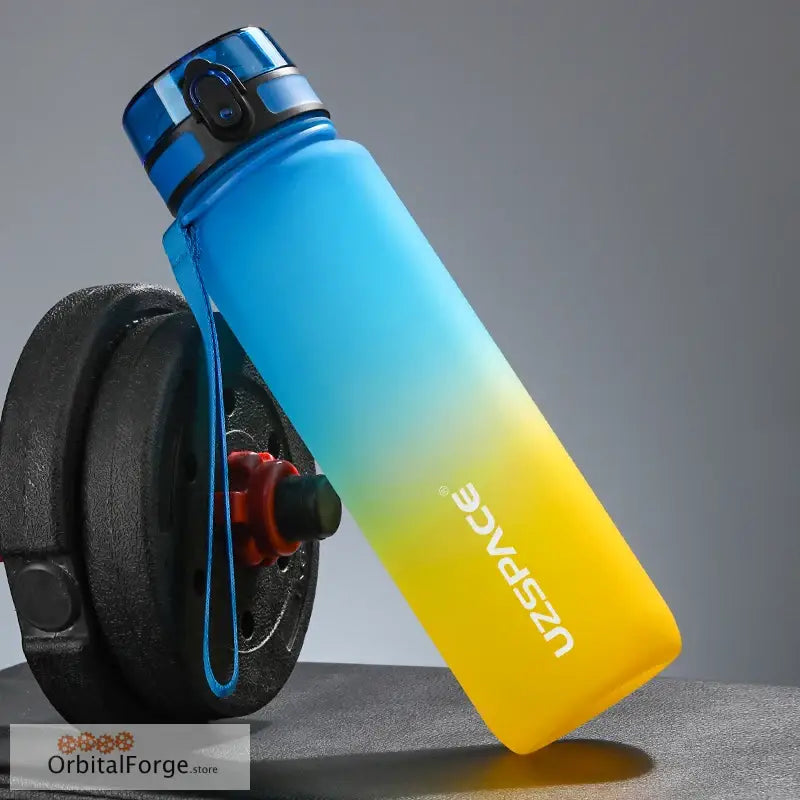 Gradient blue-to-yellow water bottle with a black cap and carrying loop.