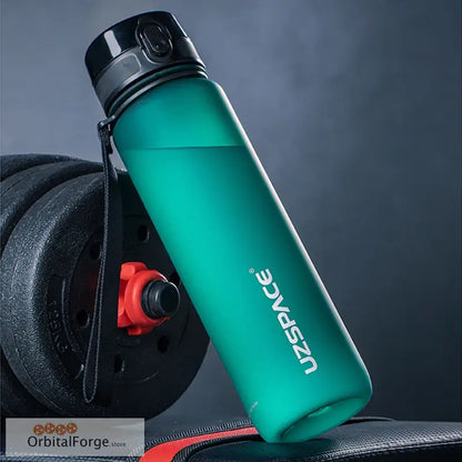 Turquoise reusable water bottle with a black cap and carrying strap.