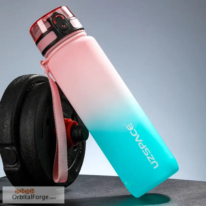 Pink and turquoise gradient reusable water bottle with a flip-top lid.