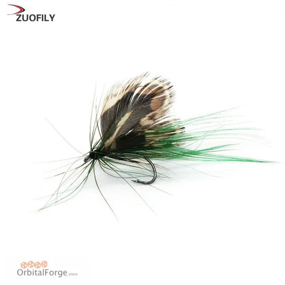 Fishing fly made with brown and green feathers tied around a hook.