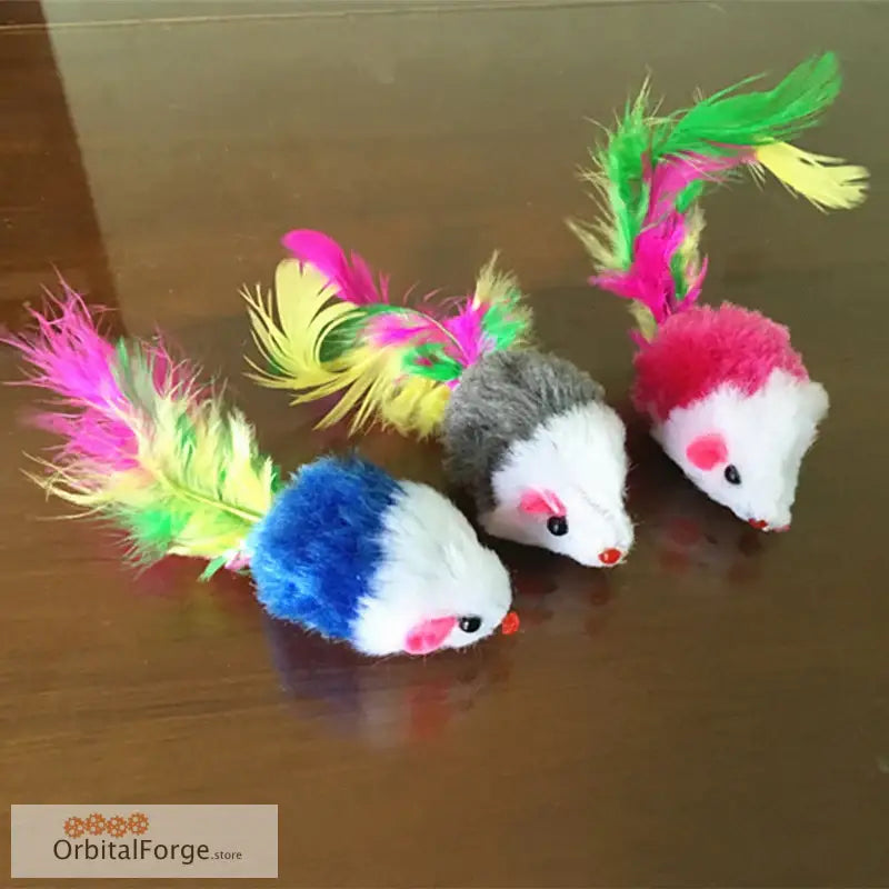 Three colorful feathered toy mice with pink noses and fluffy tails.