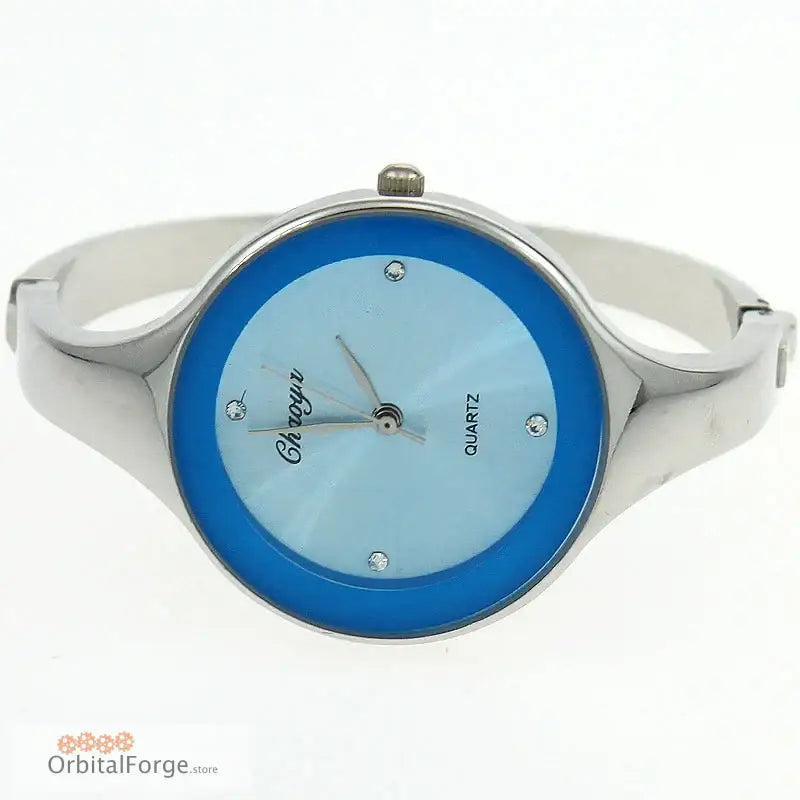 Sleek stainless steel women’s cuff watch with a blue face and minimal markings