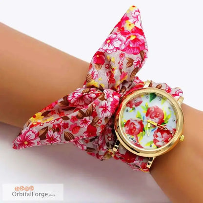 Floral fabric bracelet watch with gold case and flower-patterned face displayed elegantly