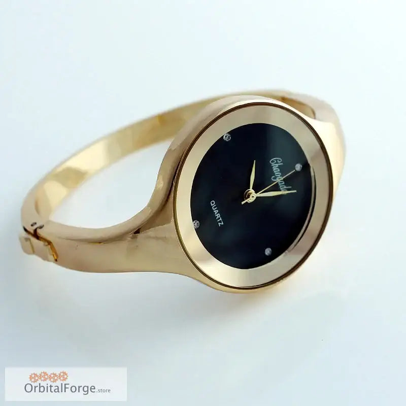 Gold-toned women’s cuff watch with stainless steel bracelet and black dial face