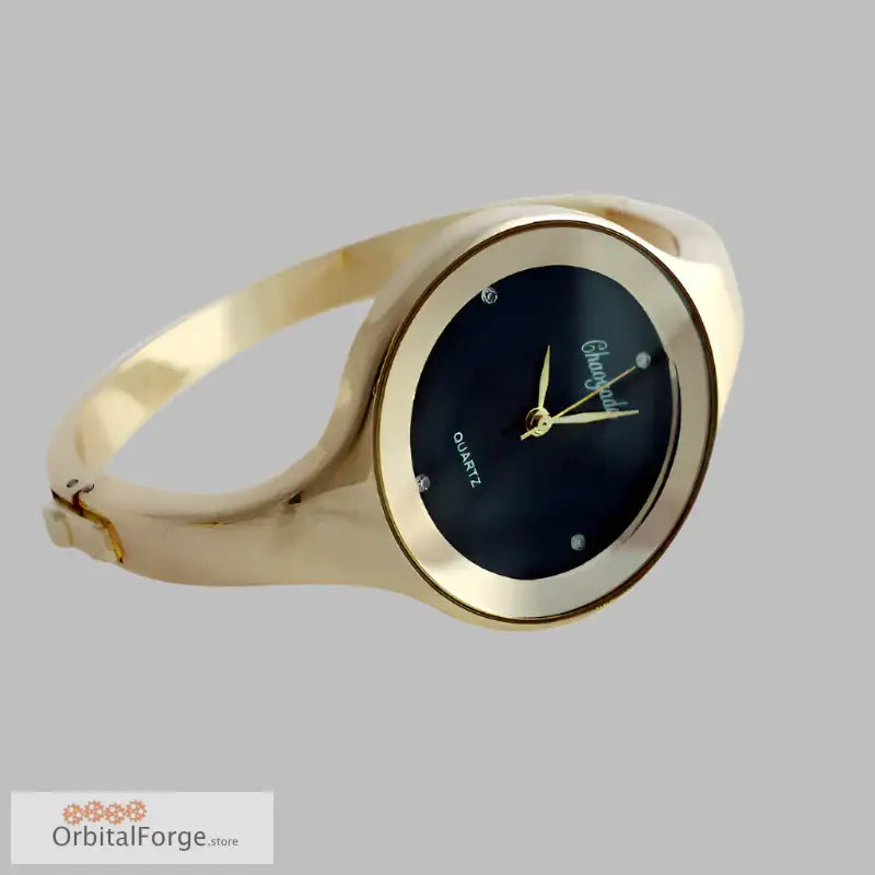 Gold-toned women’s cuff watch with stainless steel bracelet and black dial face