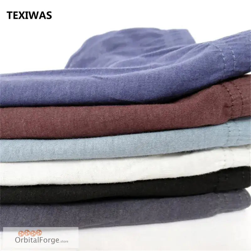 Stack of colorful folded cotton t-shirts for men’s everyday wear and bikini underwear