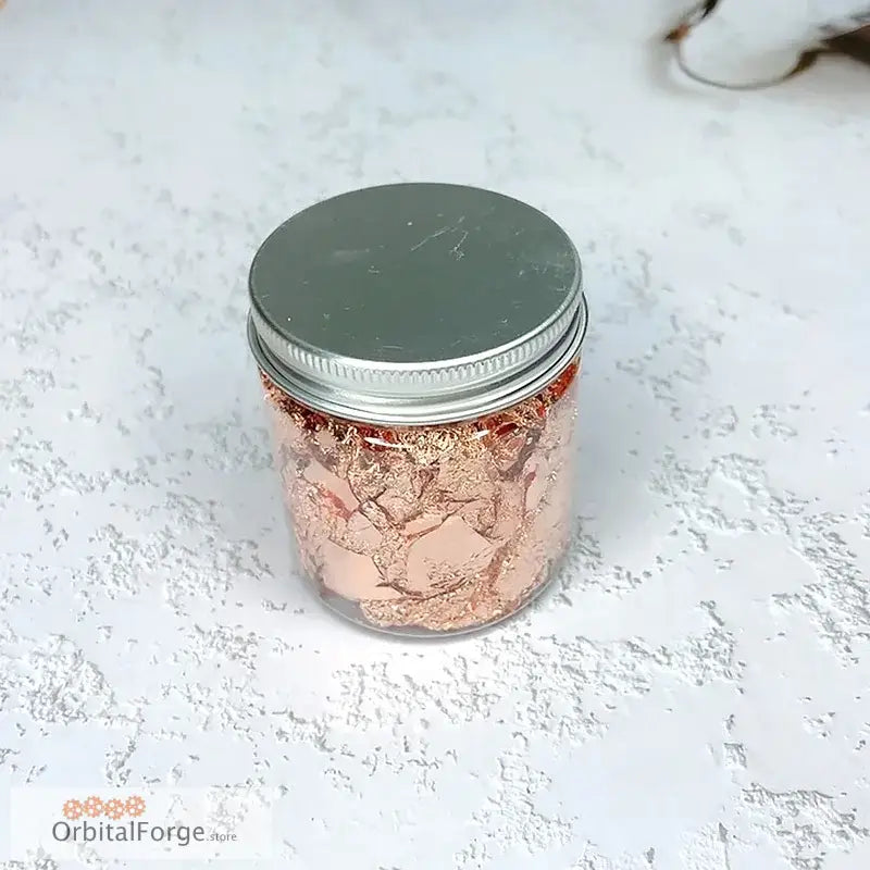 Jar filled with rose gold foil flakes.