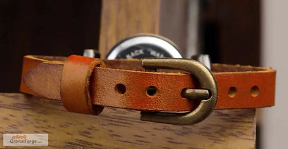 Brown leather belt with metal buckle complementing Vintage Roman Numeral Wristwatch